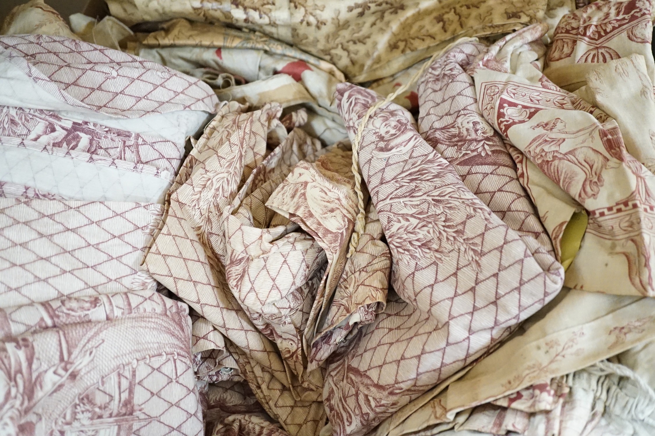 Two pairs of late 19th early 20th century French toile de jouy curtains and two matching pelmets, a floral pair of curtains, a bedspread and matching cushion covers and various glazed chintz samples